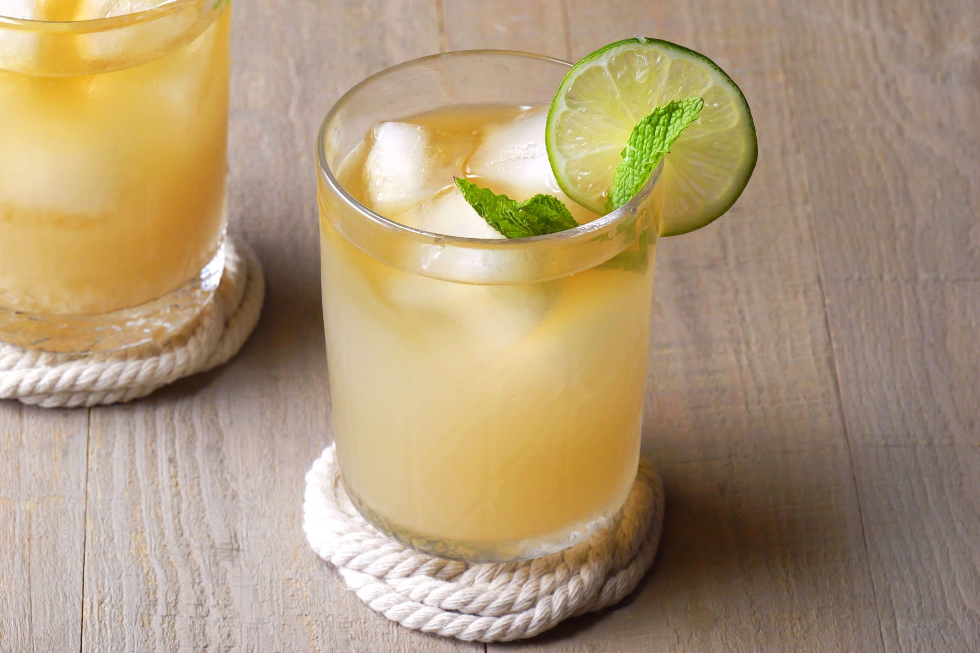 Mai Tai served into double rocks glass garnished with lemon and mint leaves