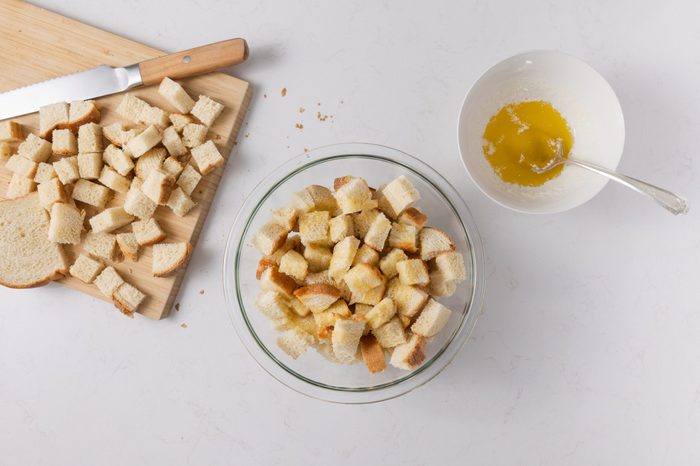 Baked bread cubed and mixed with melted butter.