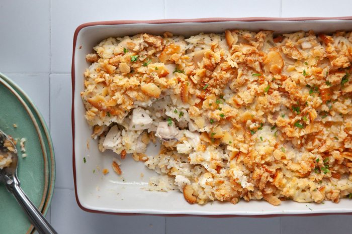 Step 2 of Taste of Home Poppy Seed Chicken is to add the chicken mixture to an 11x7 baking dish and top with buttered crackers mixed with melted butter