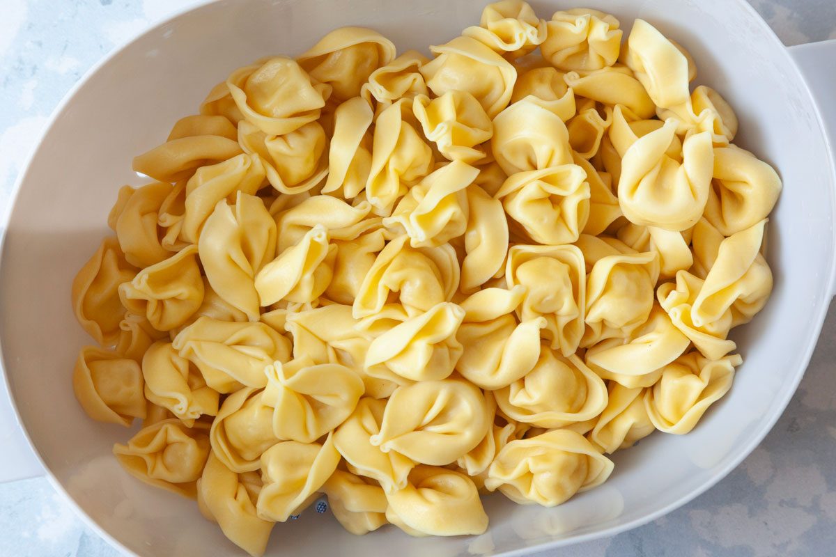 Step 1 of Taste of Home Tomato Tortellini Soup is to cook the tortellini according to package directions