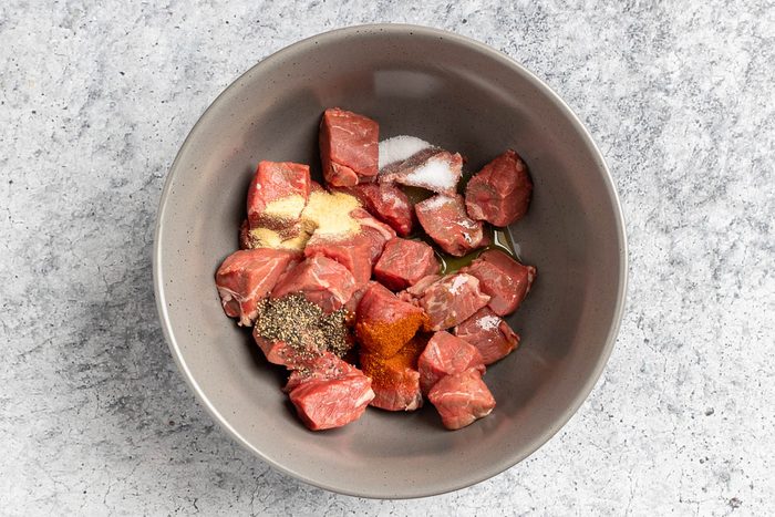 Taste of Home Air Fryer Steak Bites recipe photo of steak tossed with seasoning in a bowl.