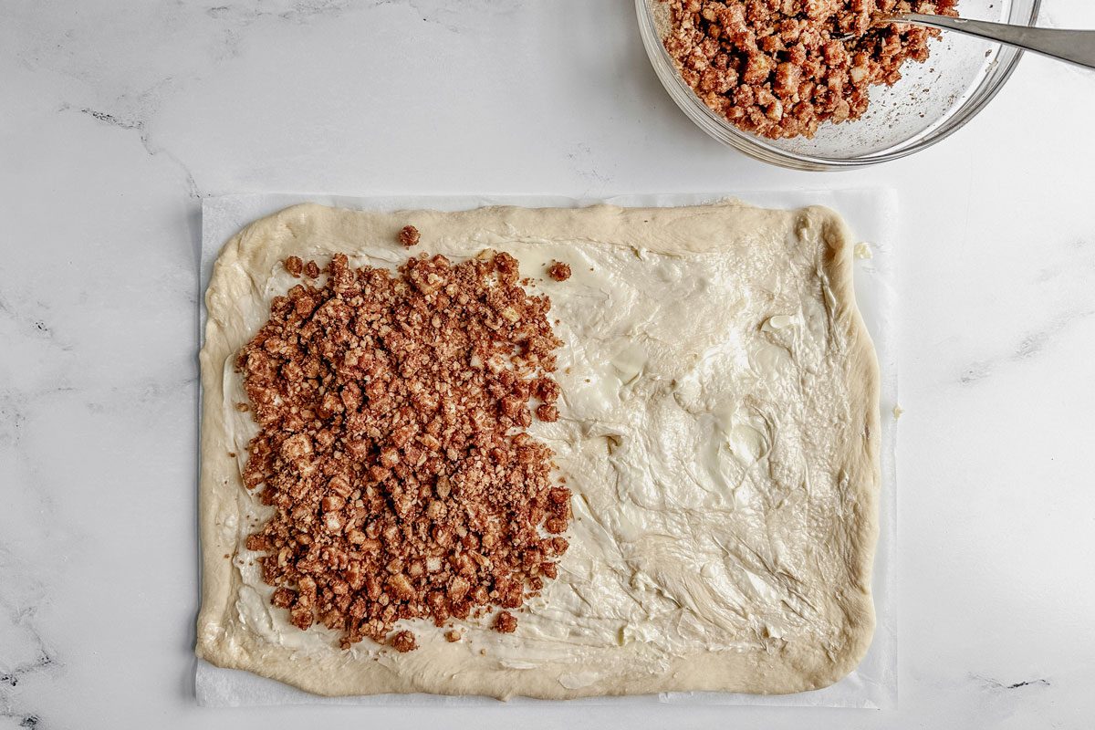 Dough partially spread with apple cinnamon filling for Taste of Home apple cinnamon rolls.