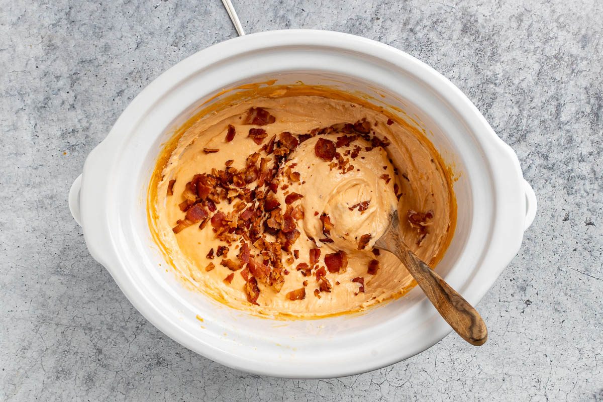 Taste of Home Bacon Dip recipe photo of the bacon crumbles stirred into the cheese sauce. 