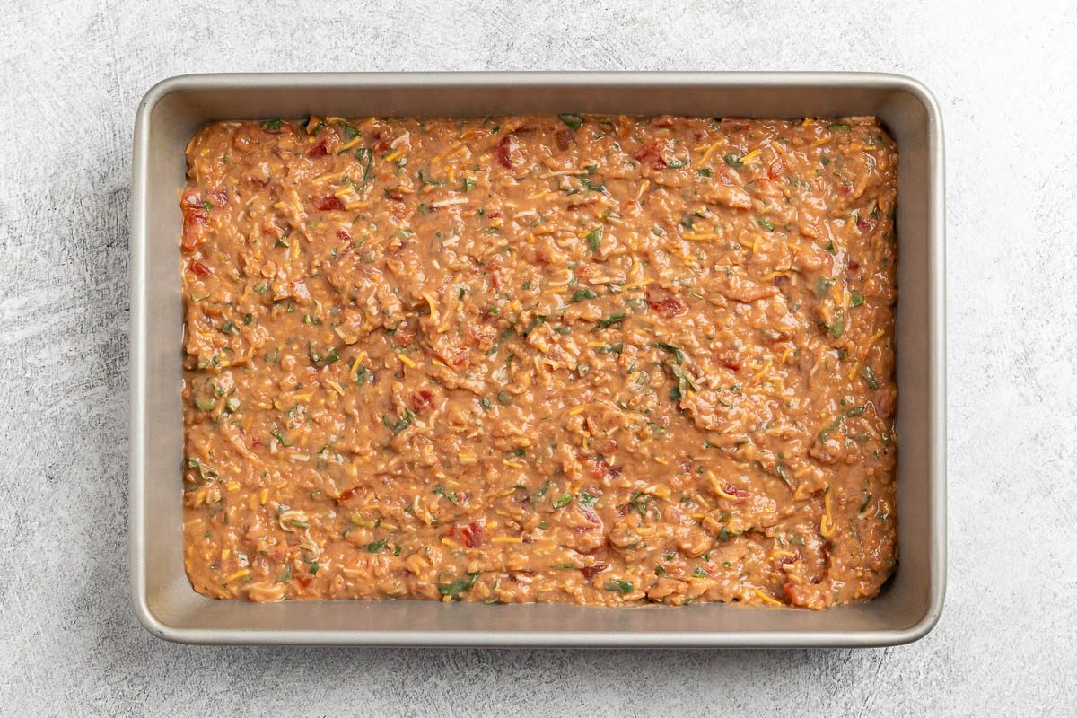 Taste of Home Baked Tacos recipe photo of the refried beans mixture layered into a baking dish.