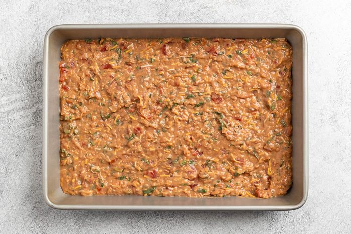 Taste of Home Baked Tacos recipe photo of the refried beans mixture layered into a baking dish.