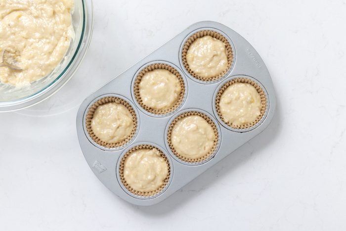 Muffins dough in baking tray ready to go in the oven.