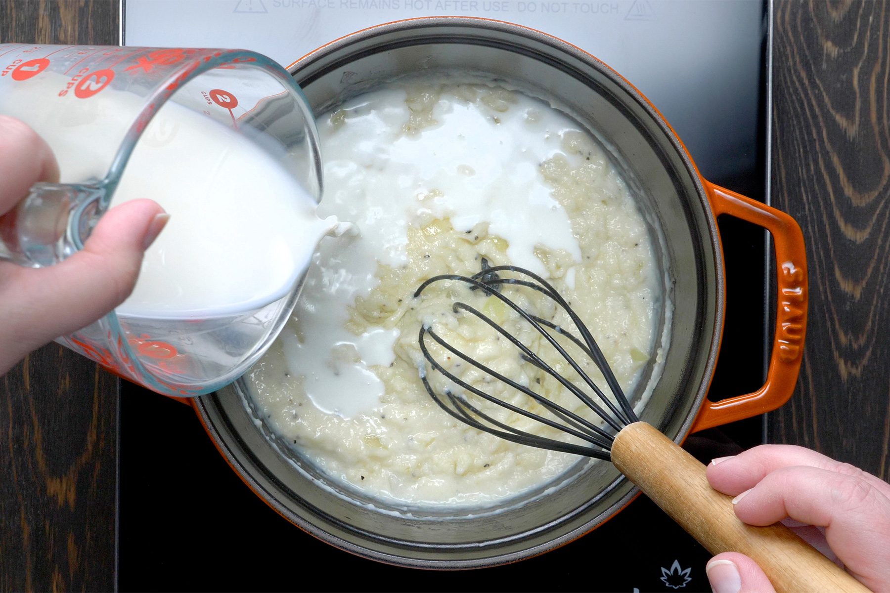 overhead shot; wooden background; Stir in the flour, salt and pepper until blended; gradually adding milk and broth;