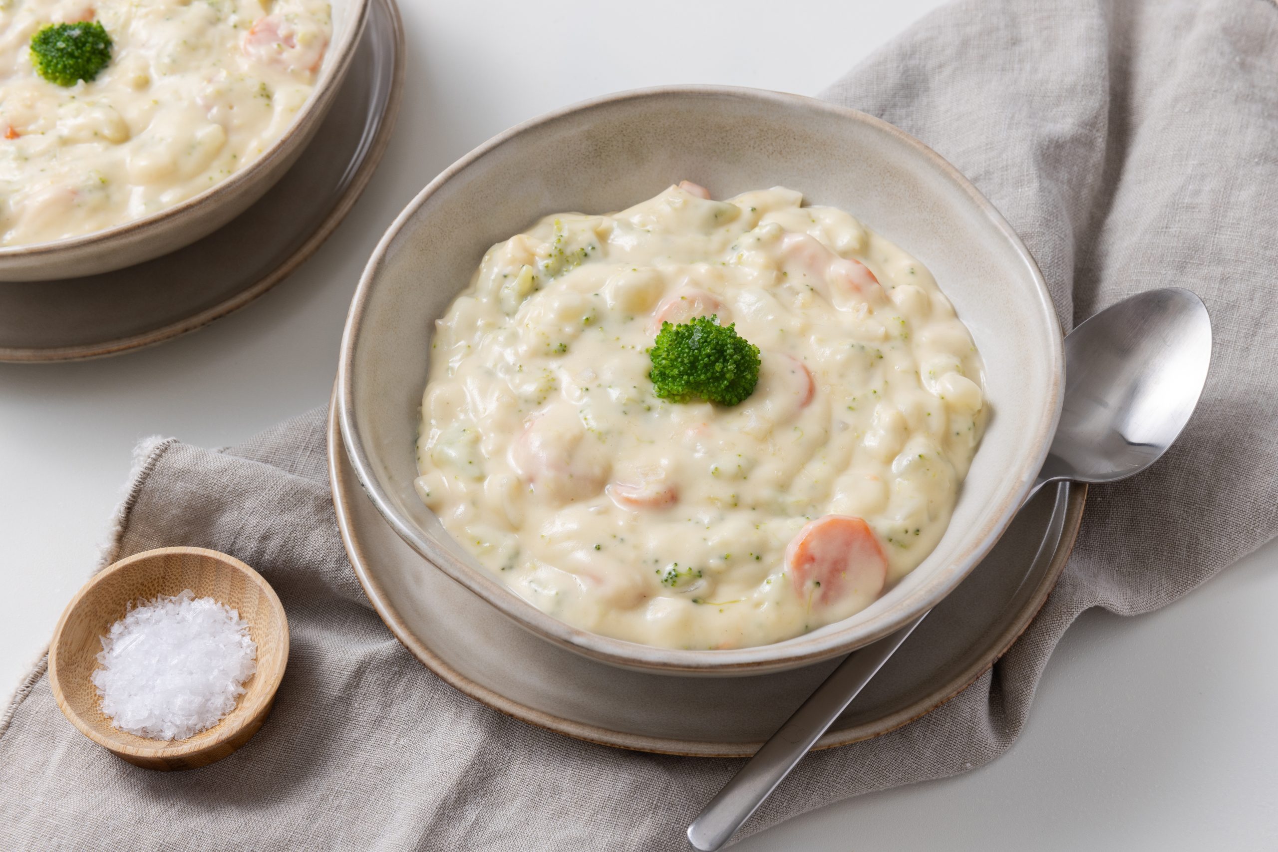 Broccoli cheese soup served in bowls..