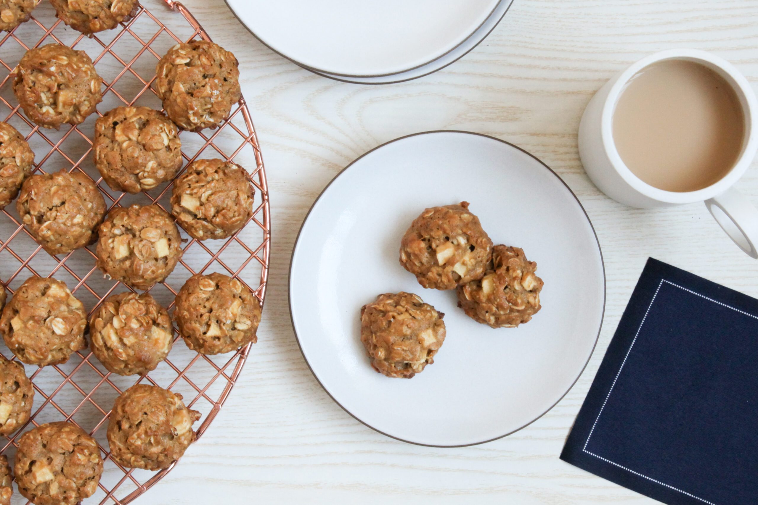 Caramel Apple Cookies on a plate with a mug of tea