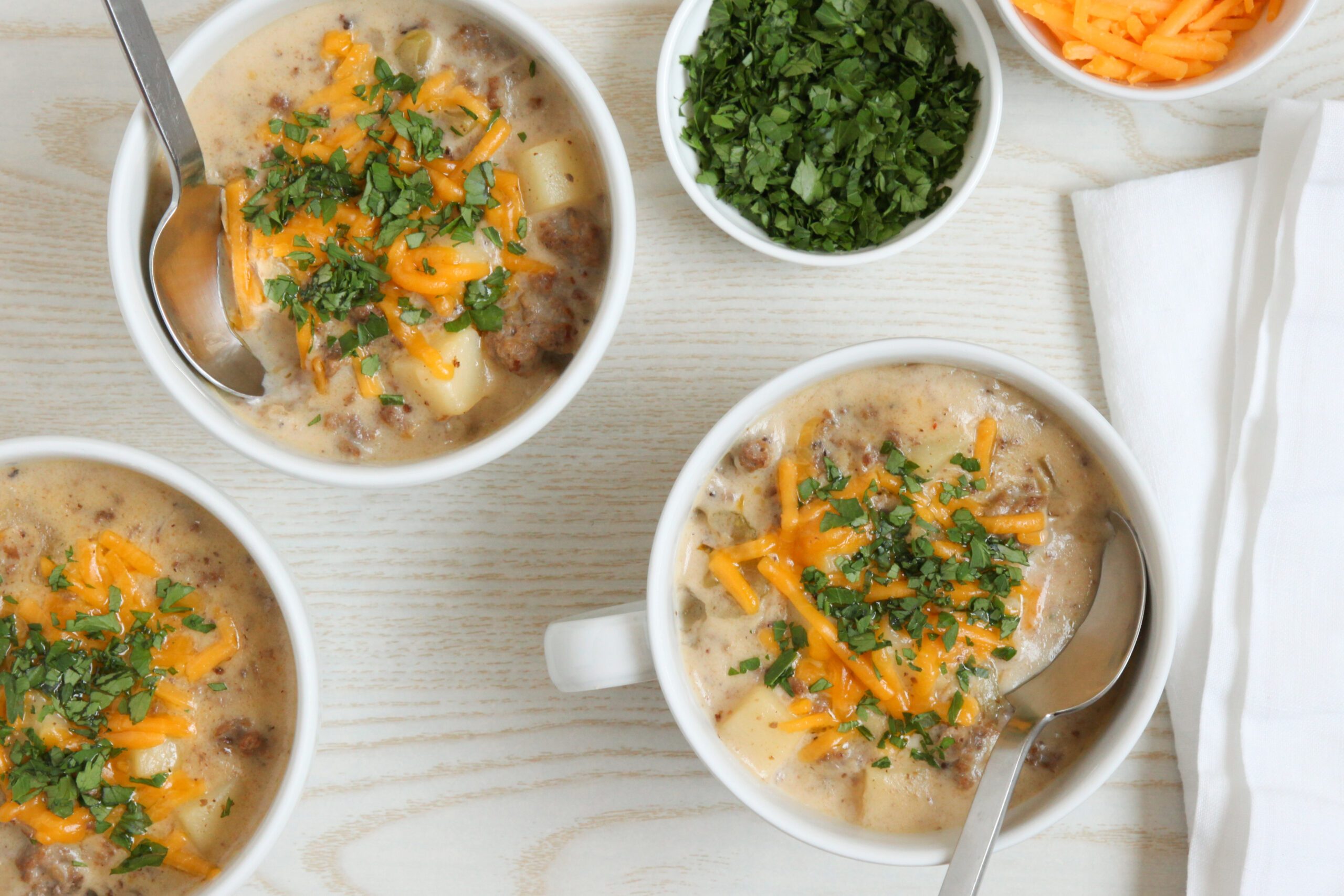 Cheeseburger Chowder topped with melted cheese and parsley