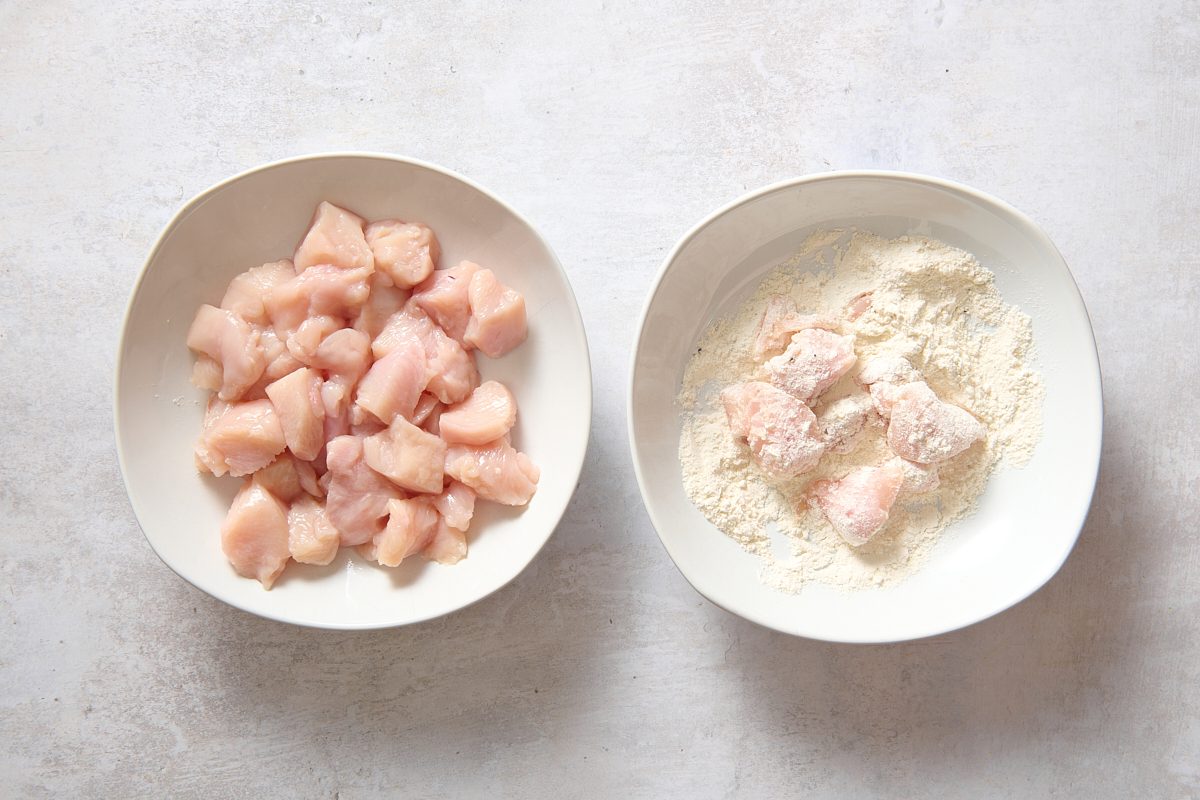 Dredging chicken pieces in the flour mixture