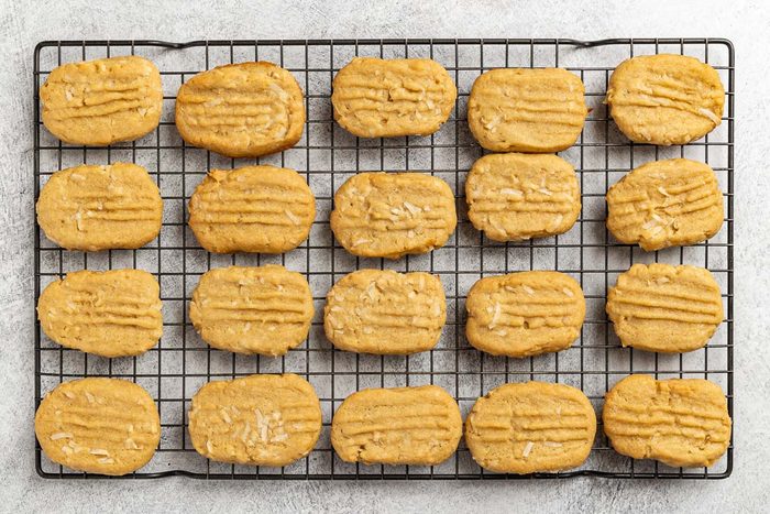 Taste of Home Coconut Cookies recipe photo of the shaped and baked cookies on a cooling rack.