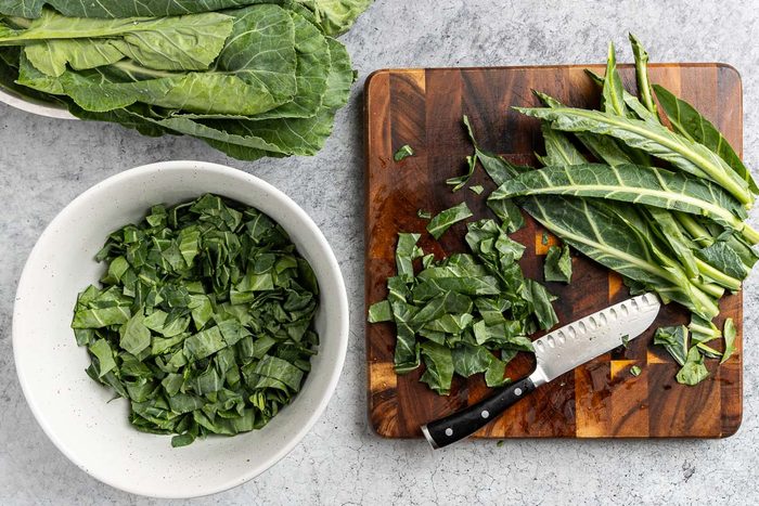 Taste of Home Collared Greens with Bacon recipe photo of chopping the collard greens.