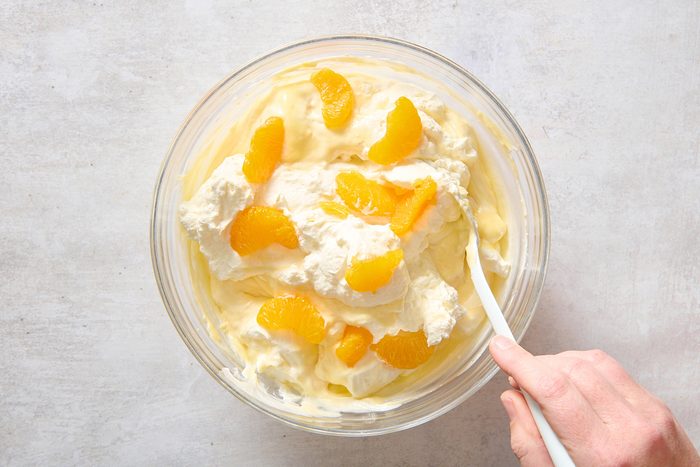 Folding in whipped topping and mandarins