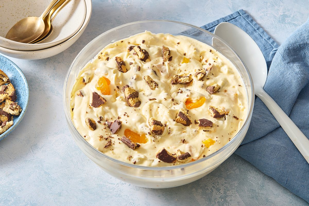 Cookie salad served in a large bowl and topped with crumbled fudge cookies and mandarin oranges