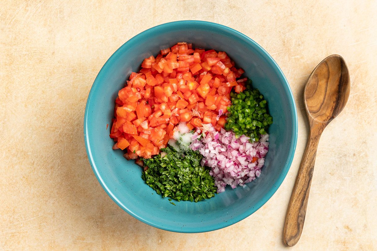 Taste of Home Copycat Chipotle Pico de Gallo recipe photo of all the finely chopped ingredients in a mixing bowl.