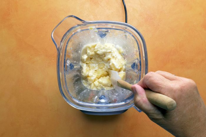 Stopping and scraping sides as needed with spatula