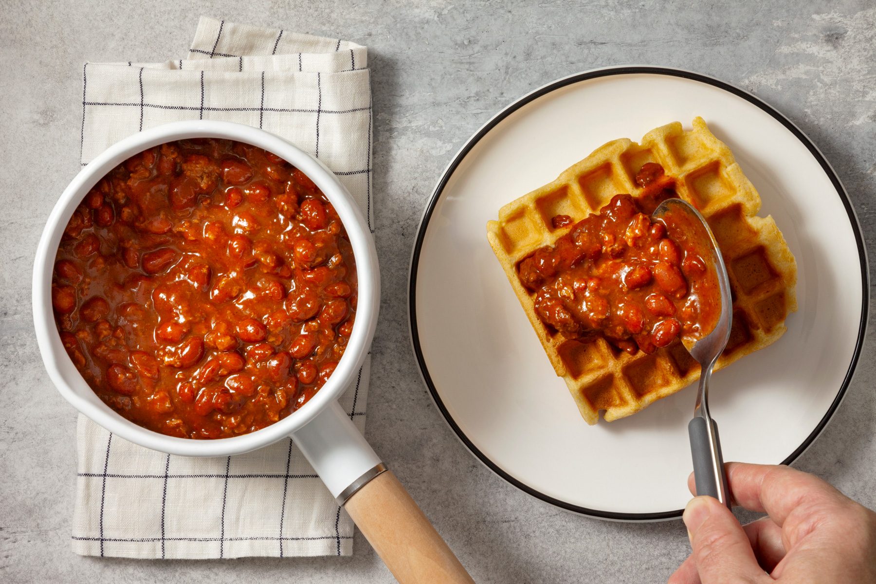 Top view shot of garnishing waffles with chillies