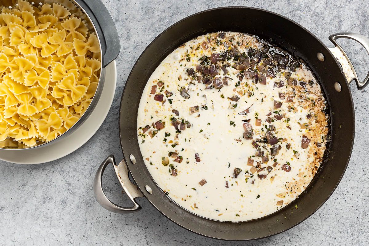 Taste of Home Cream Sauce for Pasta recipe photo of the cooked pasta and the cream sauce ingredients in a skillet.