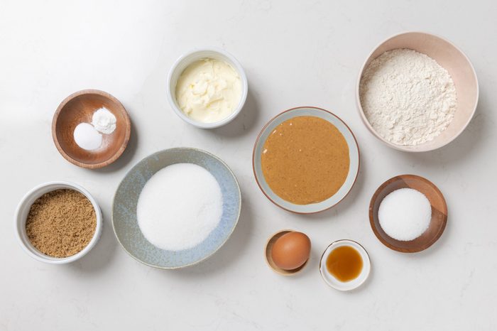 Ingredients for crunchy peanut butter cookies on kitchen counter.