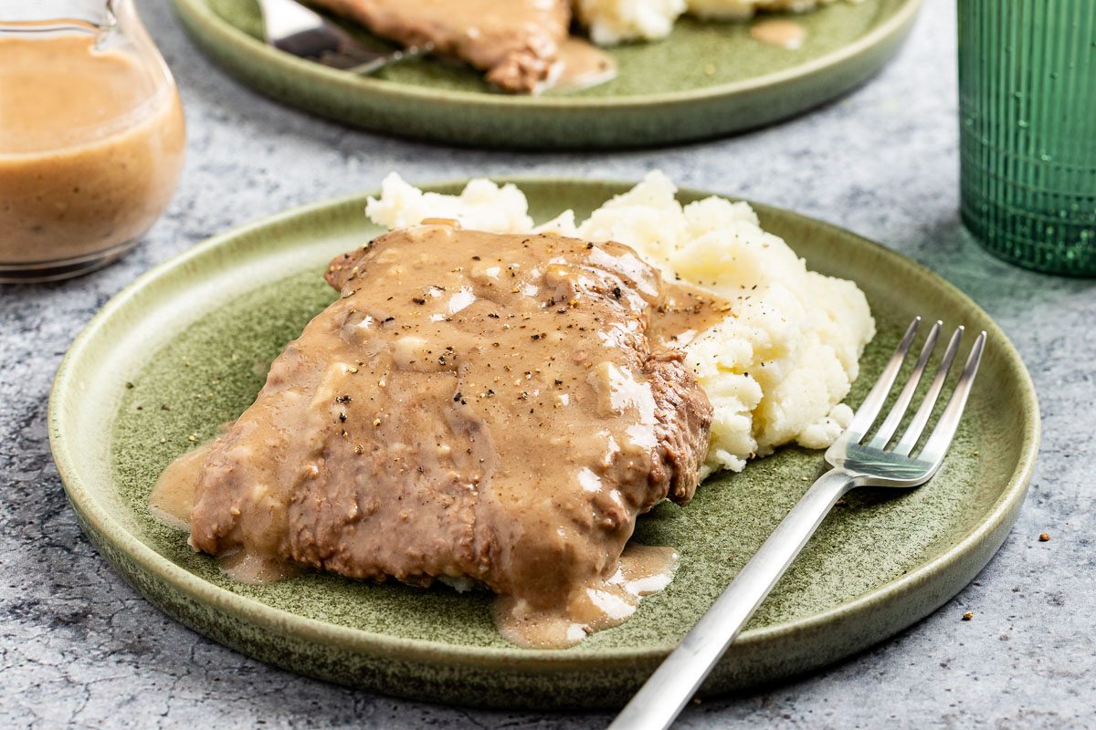 Taste of Home Cubed Steak in Crock Pot recipe photo of the finished recipe served on plates.