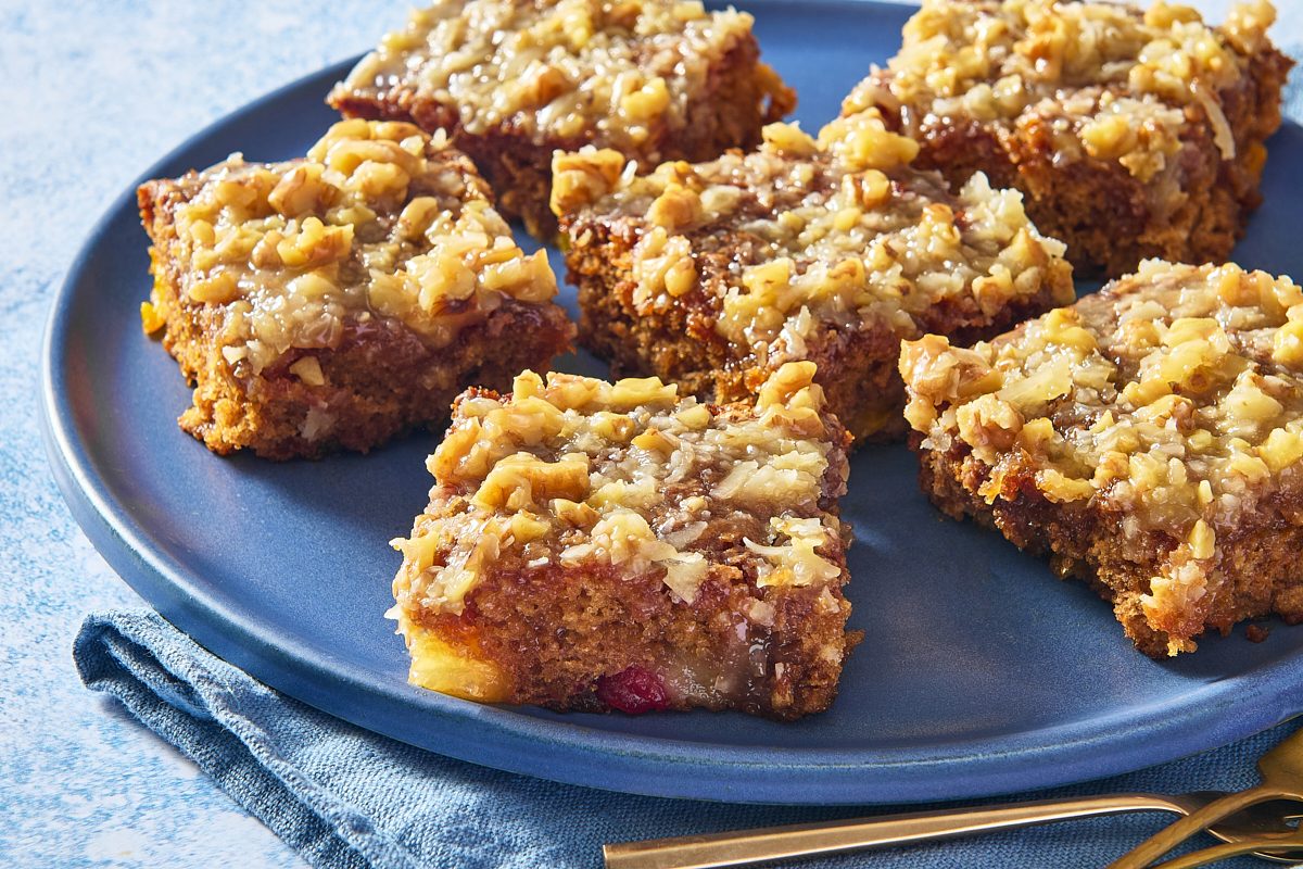 Closeup shot of slices of fruit cocktail cake served on a large plate