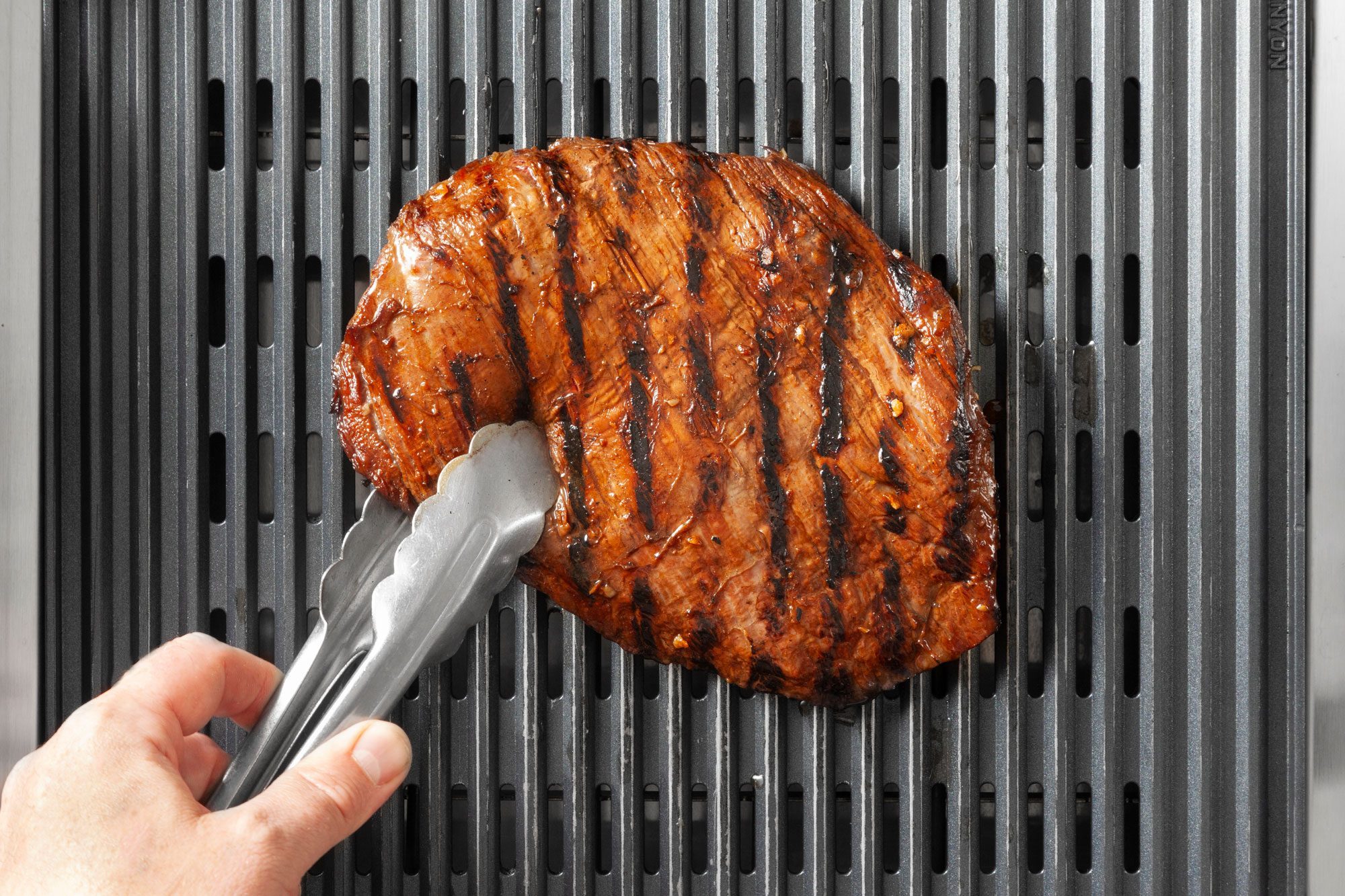 Turn over the grilled steak