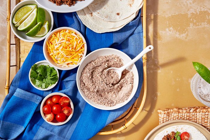 Homemade Taco Seasoning Hero- seasoning in a bowl with taco toppings surrounding