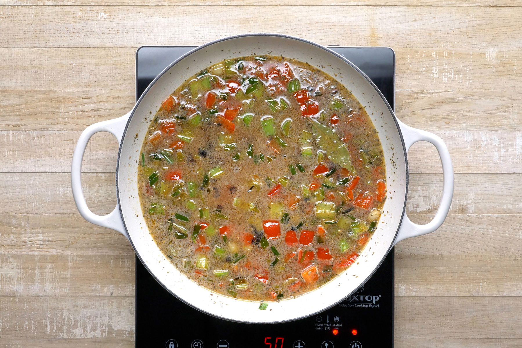 Top view shot of rice, water added to vegetables