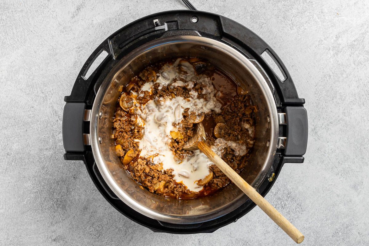 Taste of Home Instant Pot Beef Stroganoff recipe photo of adding the flour and water to the pressure cooker.