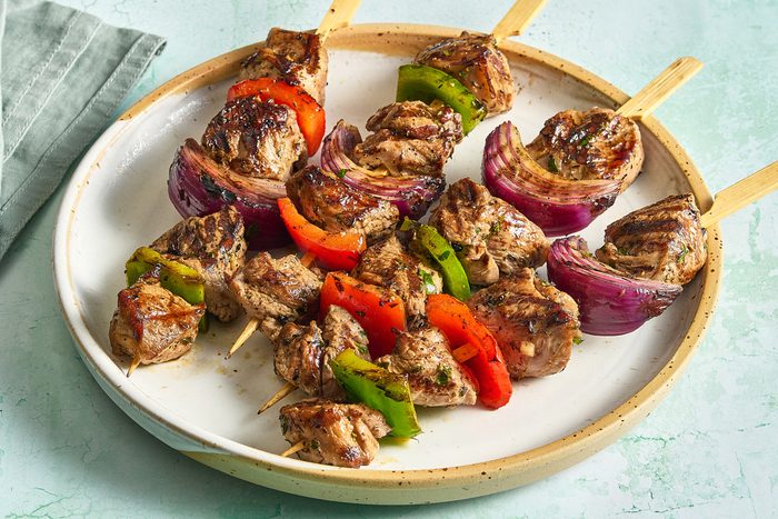 Angled shot of lamb kabobs arranged on a plate