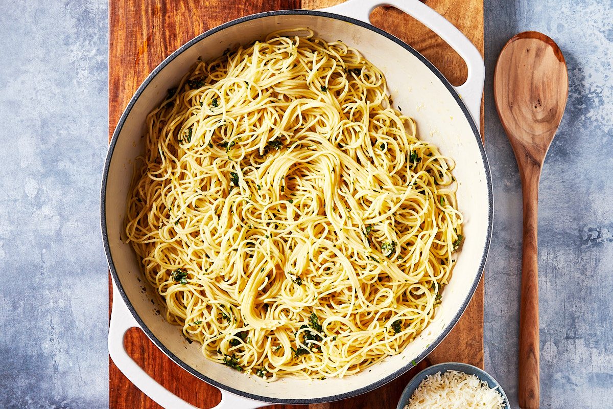 Lemon Pasta Step 2- Pasta added to skillet and tossed with sauce, parmesan in frame.