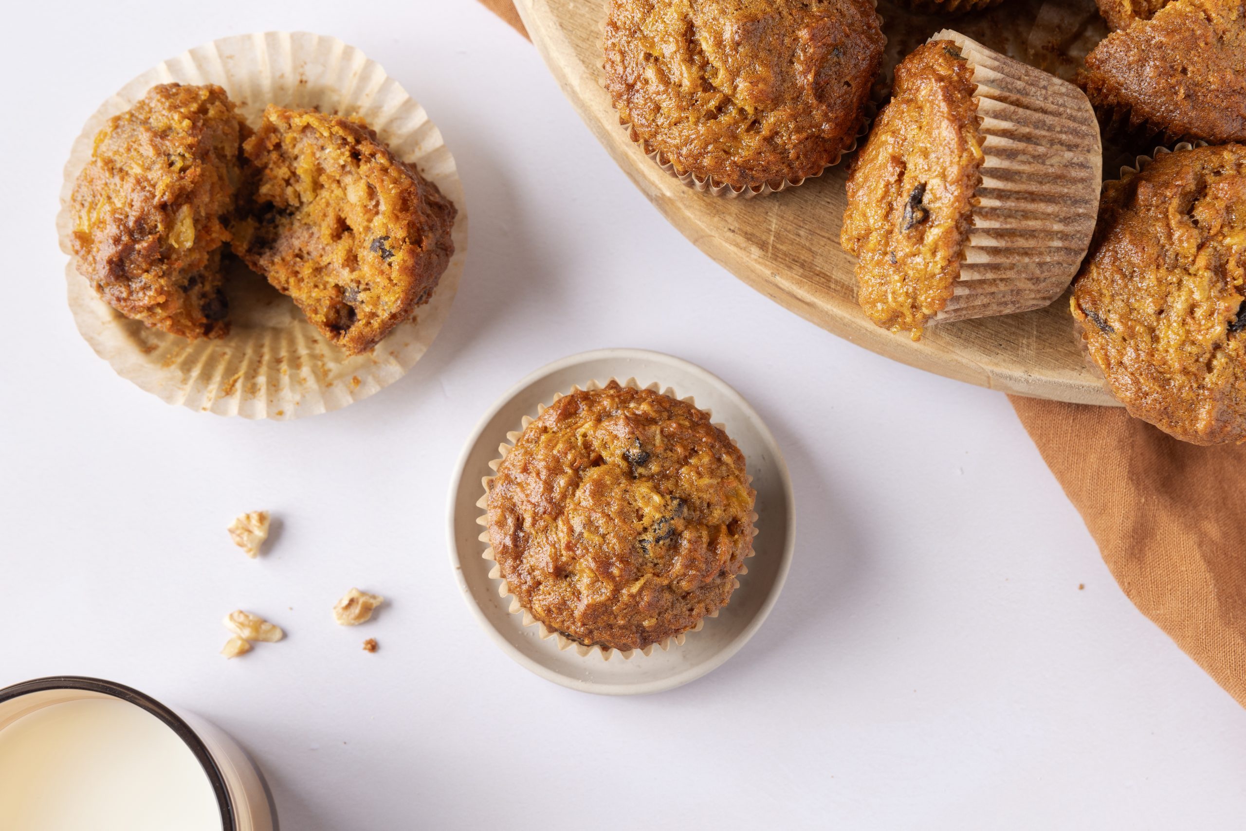 Muffins displayed on little plates and wooden board.