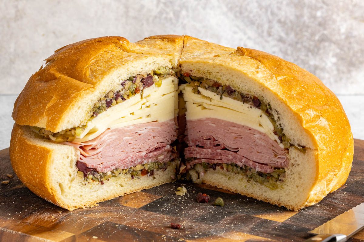 Taste of Home Muffuletta Recipe photo of the finished recipe cut into slices and served on plates.