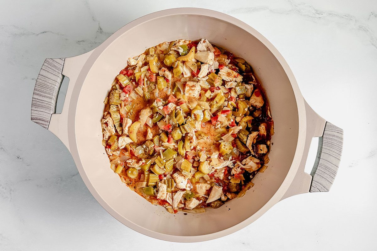 Taste of Home okra gumbo in a Dutch oven on a marble surface.