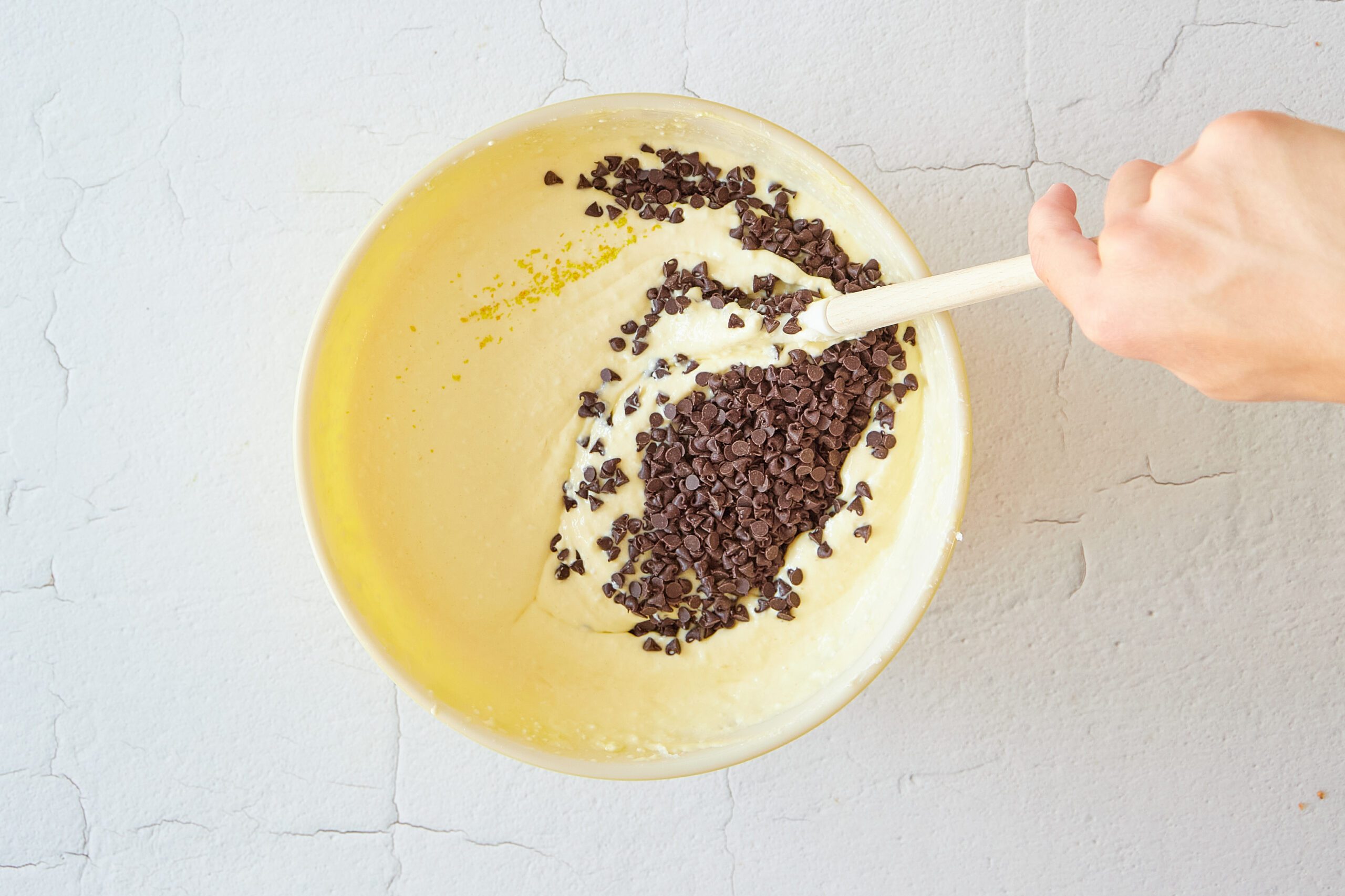 Mix the batter for the chocolate chip cheesecake.