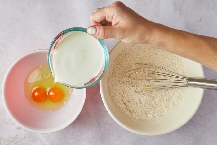 Mix the wet ingredients for cornbread pancakes.