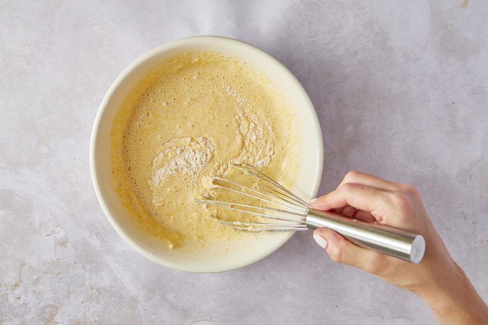 Mix the wet and dry ingredients for cornbread pancakes together.