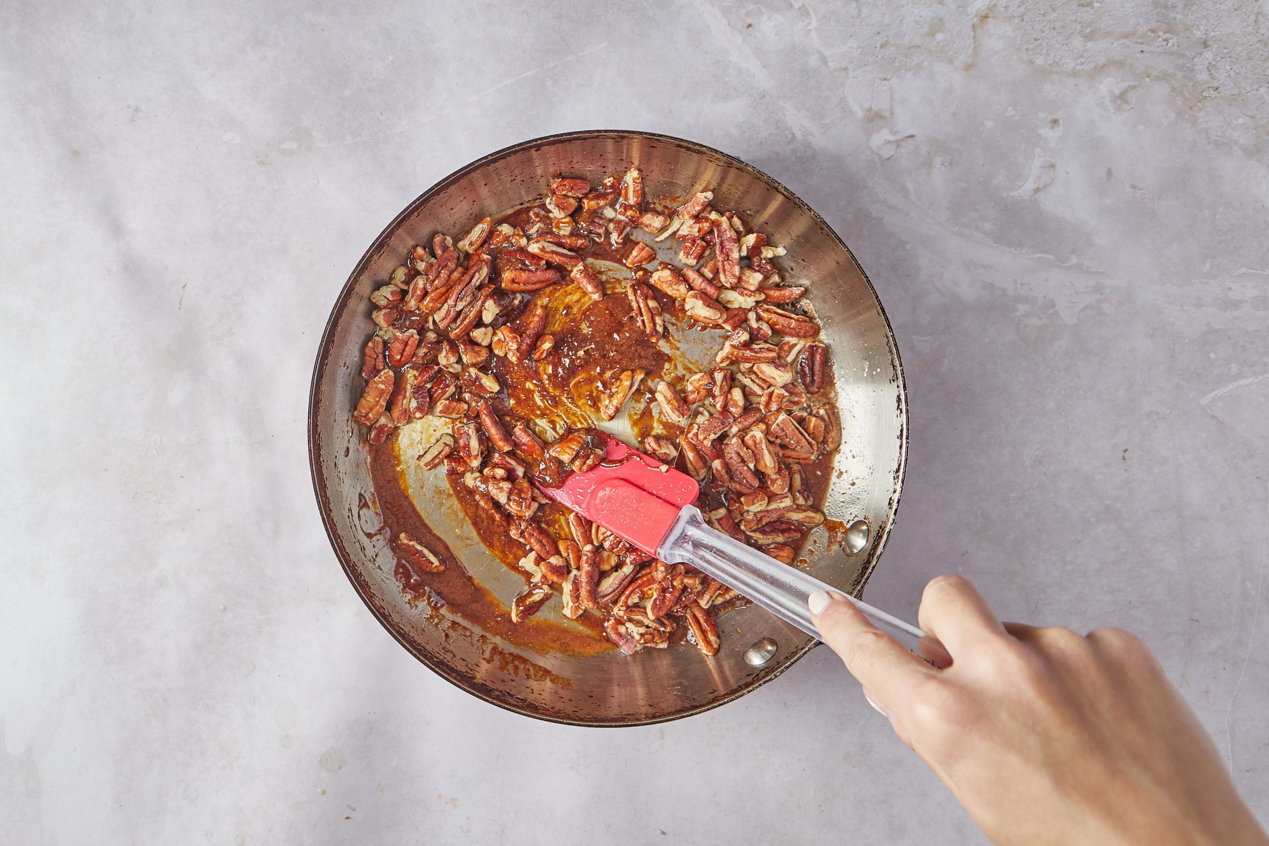 Make the candied pecans for the praline ice cream.