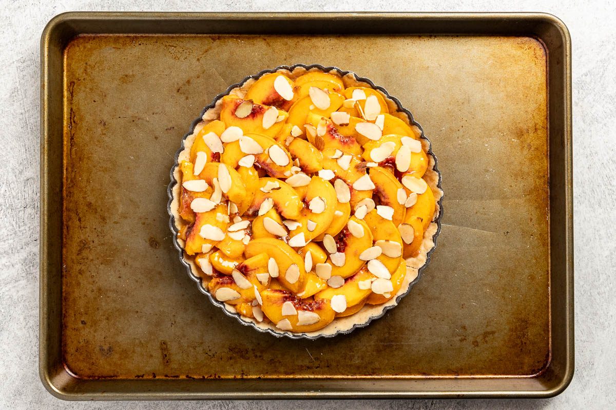 Taste of Home Peach Tart recipe photo of the peach filling sprinkled with almonds. 