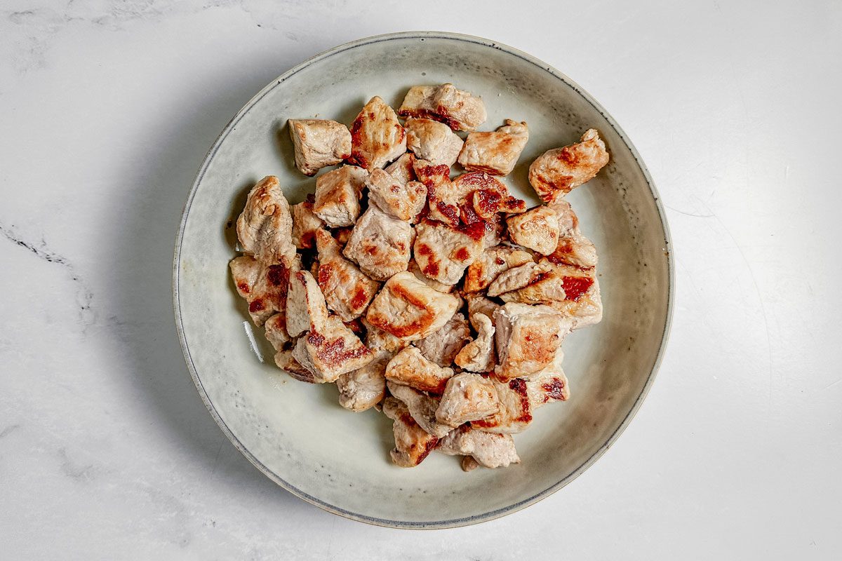 Browned pork in a ceramic bowl for Taste of Home pork stroganoff