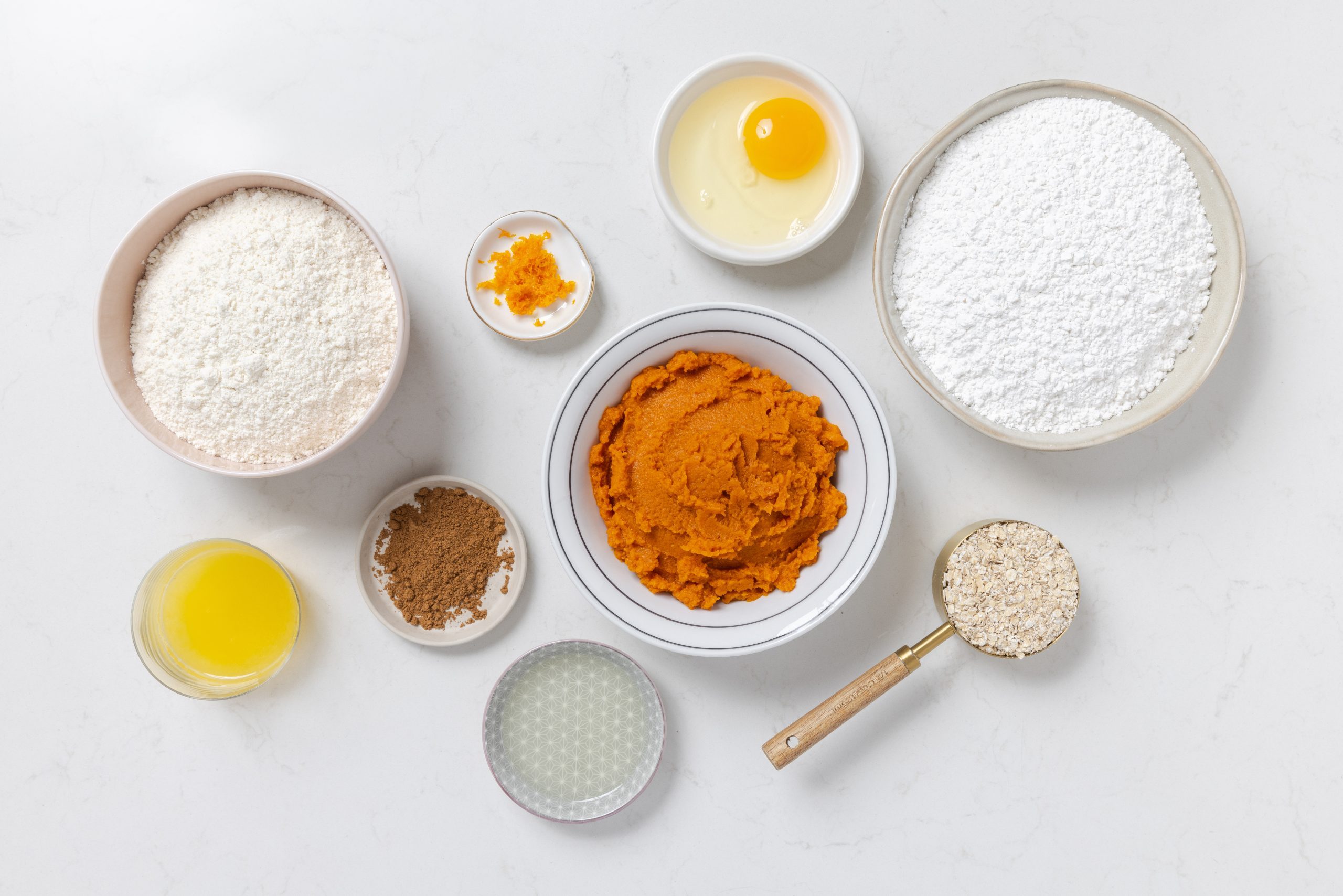 Ingredients for pumpkin spice cookies on kitchen counter.