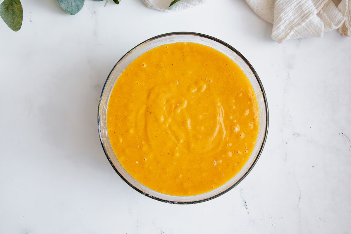 Overhead shot for Taste of Home Pumpkin Sheet Cake with cake batter mixed in a glass bowl.