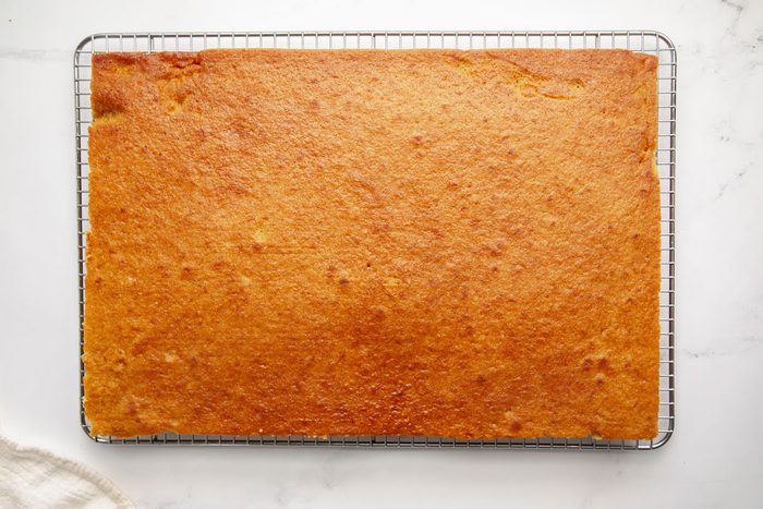 Overhead shot for Taste of Home Pumpkin Sheet Cake, cake cooling on a wire rack.