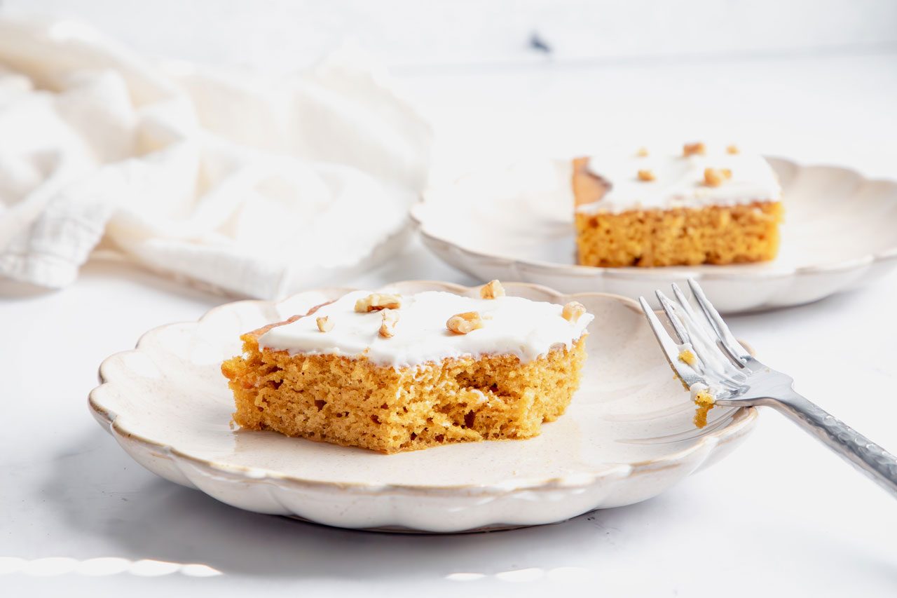 Close up beauty shot for Taste of Home Pumpkin Sheet Cake on a marble surface.