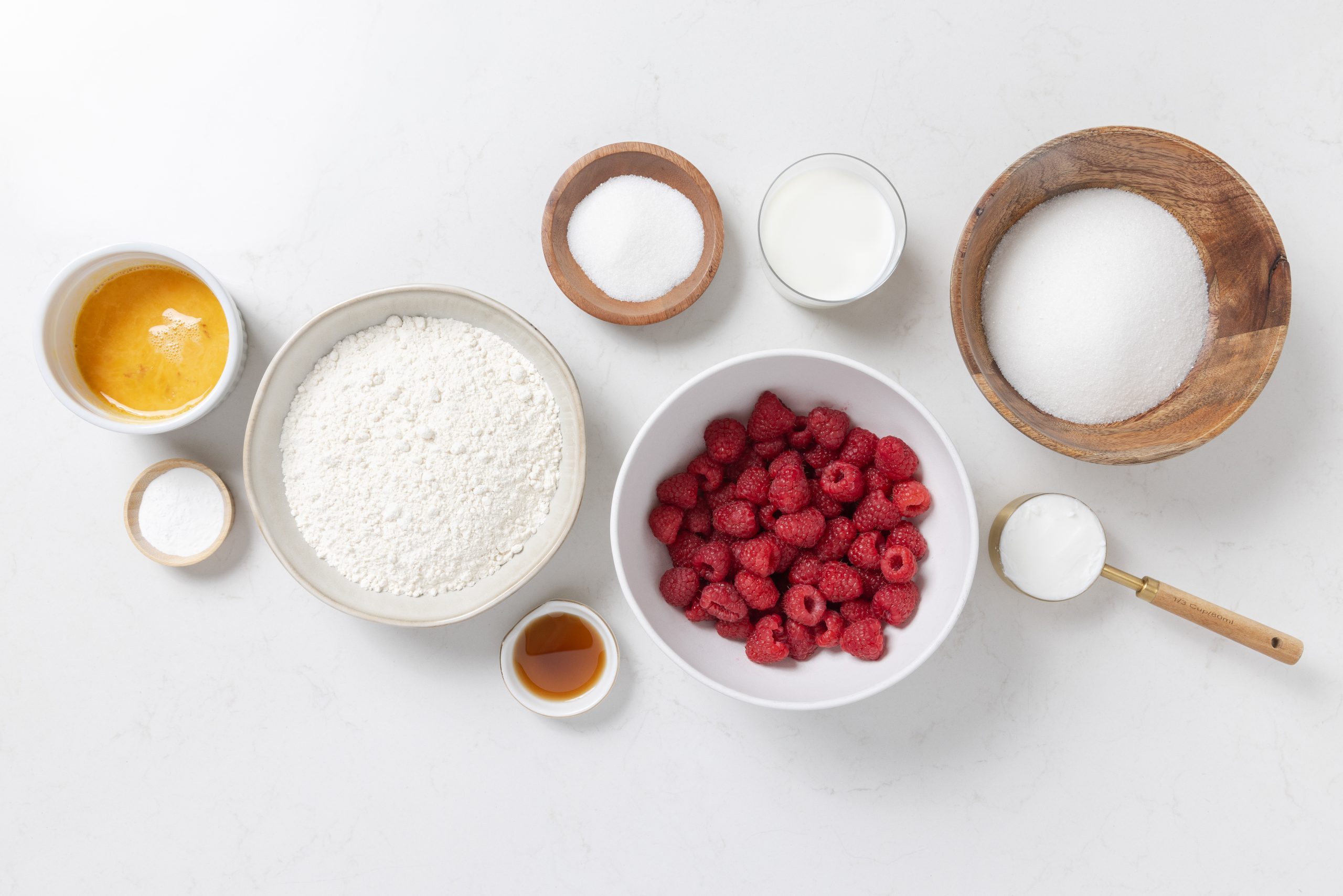 Ingredients for raspberry muffins on kitchen counter.