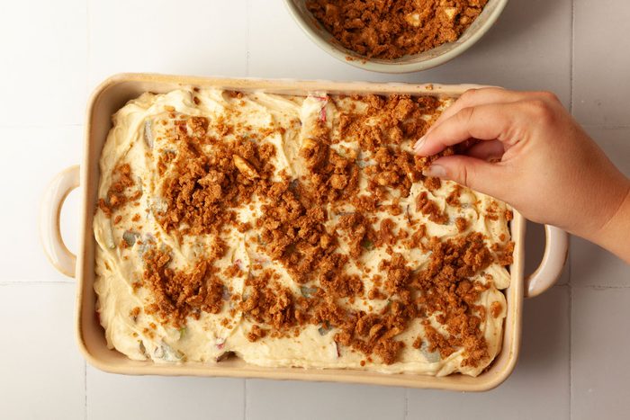 Step 3 of Taste of Home Rhubarb Coffee Cake is to combine the brown sugar, flour and cinnamon. Using your hands or a butter knife, cut in the cold butter until the mixture resembles coarse crumbs. Sprinkle this over the top of the batter.