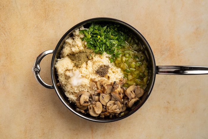 Taste of Home Rice Dressing recipe photo of the ingredients combined in a skillet with the sauteed onion and celery.