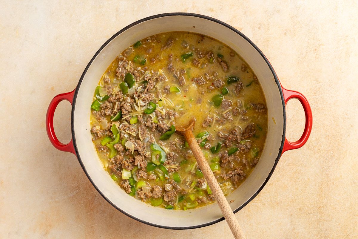 Taste of Home Sausage Rice Casserole recipe photo of the soups, rice, vegetables and sausage in a large Dutch oven.