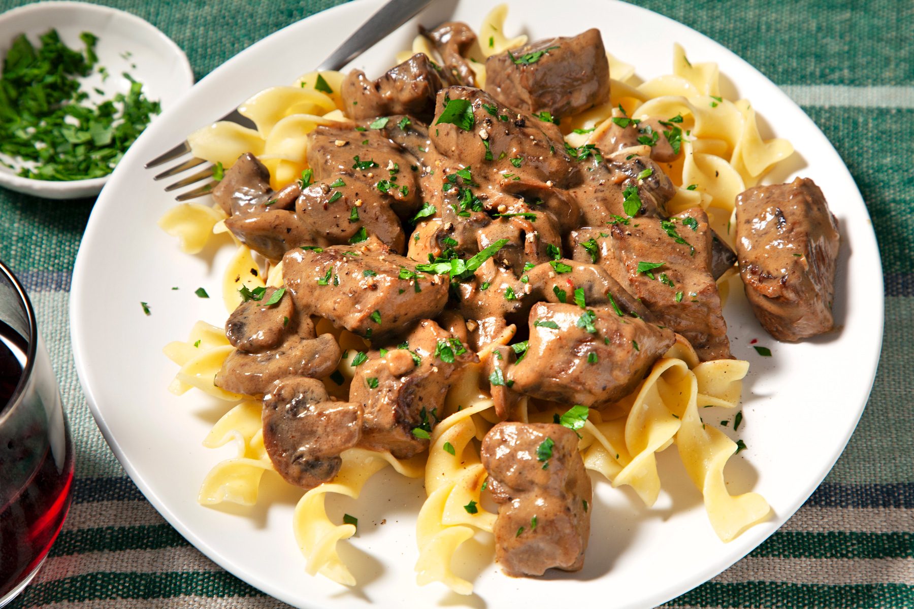 wide shot of dijon sirloin tips served with pasta